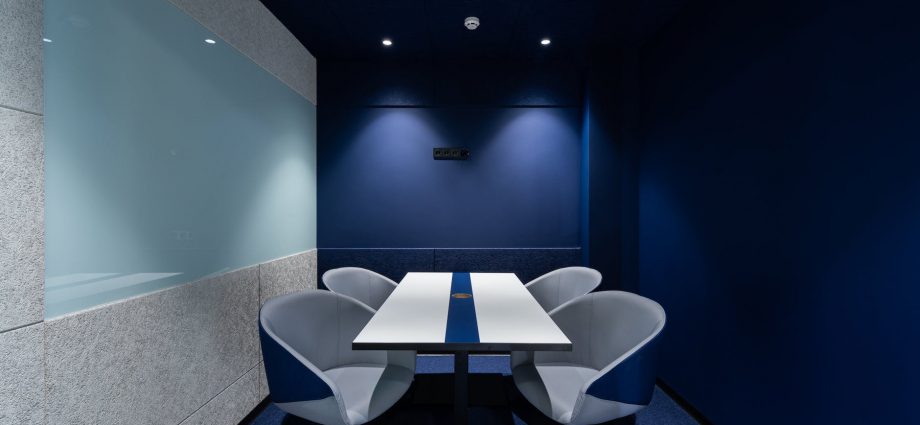 contemporary workspace with blue seats and table