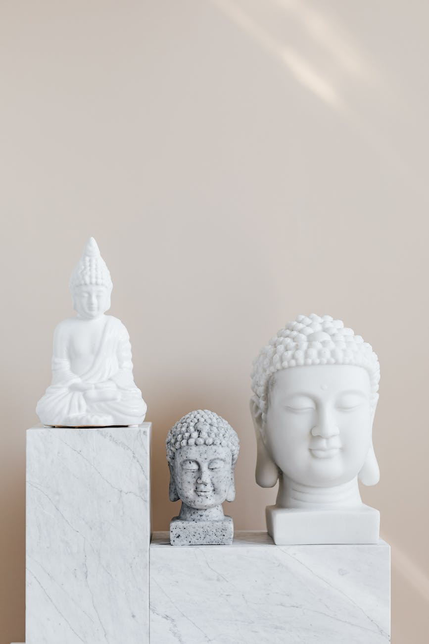 composition of buddha statues on marble stand
