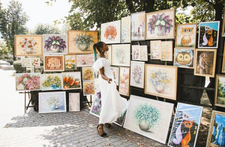 woman looking on flower painting