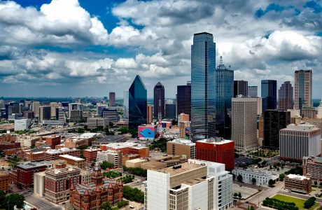 aerial photo of city under white clouds