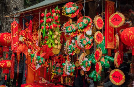 red and green chinese lanterns hanging on the store