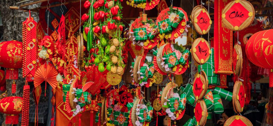 red and green chinese lanterns hanging on the store